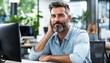© Ilja - Content business person unwinding after a productive workday in a bright and creative office space.