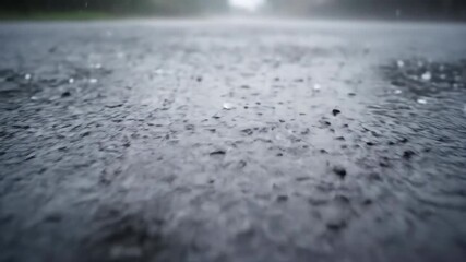 Wall Mural - Ground-level tracking shot of small, icy hail bouncing dynamically off a wet, paved surface during a brisk downpour surface, heavy rain, weather