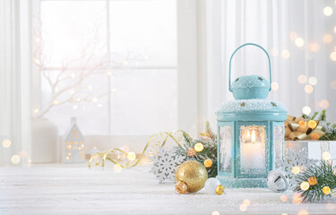 Wall Mural - Snowy wooden table space with decorated Christmas lantern, gift box, baubles and fir tree branch