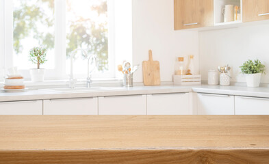 Wall Mural - Wooden table top for food presentation with blurred modern kitchen counter interior background