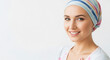 © medo - A young woman with cancer wearing a headscarf smiles