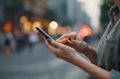 © Marina Demidiuk - Close-up of hands typing on a mobile phone, interact with technology. People use smartphone. Girl holding and using a phone, blurred city background. Point finger touch the device screen. Online wi-fi