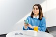 © nazariykarkhut - Businesswoman using smartphone and drinking orange juice at outdoor cafe