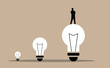 © Eugen - Silhouette of a Business Man on Big Light Bulb. White collar workers and company leader CEO looking for solution
