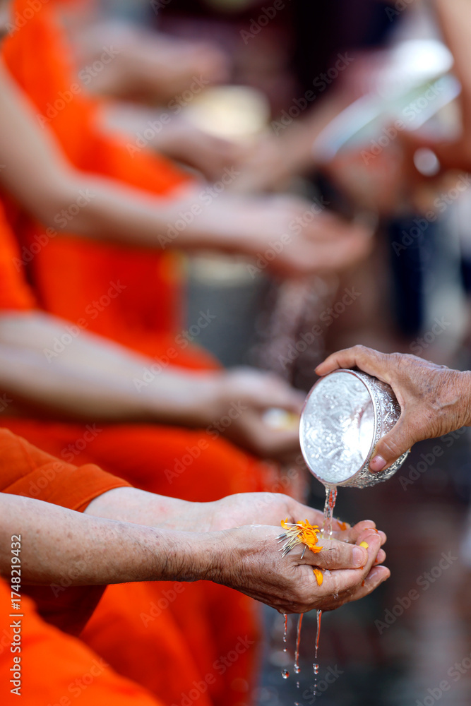 Buddhist ceremony. Worshipper washing the hands of Buddhist monks ...