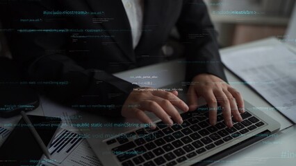 A focused programmer types on a laptop, surrounded by code snippets and documents, reflecting the dynamic nature of technology and software development in a modern workspace. Xenic
