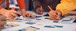 © InfiniteFlow - Diverse team members engage in a creative brainstorming session, using colorful markers to sketch ideas and develop innovative designs on a shared workspace. SACTR