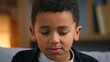 © Yuliia - Closeup upset little African American boy child looking down feeling bad stressed bored unhappy ashamed disappointed kid son family loneliness at home childhood sorrow negative emotion suffering sad