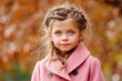 © LimeSky - Fashionable young girl 5 6 years old in a trendy pink coat at a park during autumn Posing for the camera