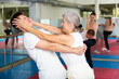 © JackF - Senior woman performing eye-gouging move while sparring with young man in gym during self-defence training.