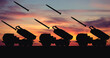 © Andrew L - Silhouette of an M142 HIMARS artillery rocket system against the backdrop of sunset. Massive rocket attack. Illustration for a design on the theme of military defense and military technology.