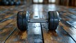 © MBRAMO - Gym dumbbell on wooden floor.  Possible use Stock photo for fitness, exercise, and workout concepts.