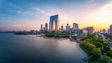 Modern cityscape skyline and skyscraper on the beautiful lakefront at sunset in Suzhou. Business and architectural background.