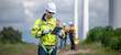 © BESTIMAGE - Male man engineer inspection by tablet gesture check control wind power machine out door wind energy factory. technician professional worker check wind power machine turbine field inspection