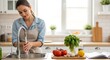 © Nando - Young woman washing her hands in kitchen before food