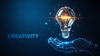 © Emongrapic - Wireframe Hand Holding Light Bulb Creativity Concept on Dark Blue Tone