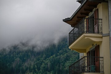 High resolution color image of a hotel balcony in the beautiful city of Chamonix- France with a cloudy alps mountain background