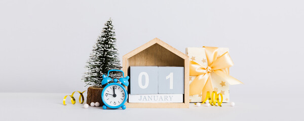 Wall Mural - 1 january. Christmas composition on colored background with a wooden calendar, with a gift box, toys, bauble copy space