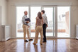 © mariamontoyart - Real estate agent in front of balcony while visit of young couple to apartment for rent