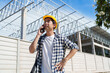 © crizzystudio - Construction supervisor talking on mobile phone at building site