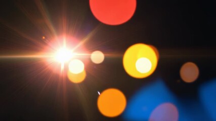 Wall Mural - Bright lens flare creating starburst and abstract bokeh lights