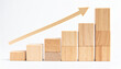 © hardvicore - Wooden bar chart with upward arrow, clean white background, business growth and progress.