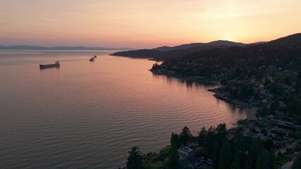 Wall Mural - A beautiful scenic drone shot of a the sun setting in Proctor Avenue, Canada.