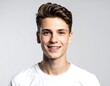 © bakol - A cheerful young man with brown hair poses for a studio portrait