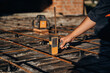 © standret - Close up view of man's hand that is using leveling tool on the floor, construction site