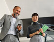 © Lumos sp - Portrait of mid aged businessman  and young businesswoman having a meeting or presentation and seminar standing in the office. Portrait of a young businesswoman  and businessman talking and walking do