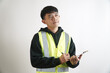 © yashis007 - engineer or construction site manager in a safety vest holding a clipboard