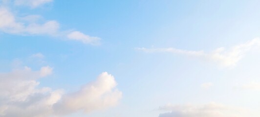 Wall Mural - Beautiful sky landscape with soft clouds in summer. Cloudy blue sky in scenic background. Soft white clouds float in the clear blue sky. Soft sky gradient, wallpaper landscape, aerial view.