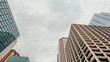 © Sanya Kushak - Low angle partial view of iconic skyscraper building architecture in downtown Chicago, Illinois. Set against a soft cloudy sky.