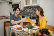 © Pichsakul - Asian couple share breakfast home kitchen toast orange juice happy morning meal together enjoy