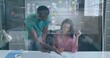 © vectorfusionart - Pointing two colleagues collaborating over printed documents at office desk, showing sticky notes