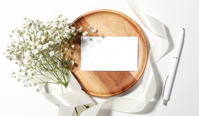 Wall Mural - Blank card, pen, ribbon and beautiful flowers on white background, flat lay