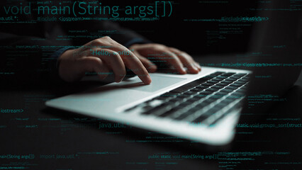 Hands actively typing on a modern laptop keyboard surrounded by abstract code elements, illustrating the essence of programming, technology, and innovation. Xenic