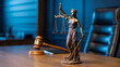 © Md.Al-amin - A professional photograph of a Themis statue, a classical representation of Lady Justice, positioned on a wooden desk in a courtroom setting.