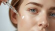 © Prime path 515 - Close up of a woman applying hydrating serum with a glass dropper to the delicate under eye area, highlighting smooth skin texture, skincare routine details, and clean beauty aesthetics for cosmetic u