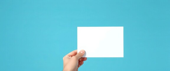Wall Mural - A hand gently holds a blank white speech bubble against a serene blue backdrop,  white,  icon