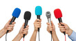 © 爱心 - Hands holding multiple colorful microphones for press conference or media interview isolated on white