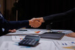 © David - B2B, handshake and partnership with business women in office at night for thank you or welcome. Bokeh, deal and mockup with employee people shaking hands for team onboarding or recruitment on space
