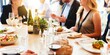© Rawpixel.com - Group dining at a restaurant, enjoying a meal with wine. People socializing, sharing food, and dining together. Restaurant ambiance with wine and food. Group of people dining at restaurant.