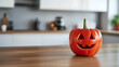 © photo for everything - Whimsical Halloween Decor: Carved pumpkin in a modern kitchen setting with a happy face, evokes seasonal charm. Festive tabletop accent piece.