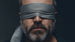 © BALOCH - Blindfolded man symbolizing trust issues, mystery, or the unknown for editorial use