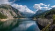 © Dian - A panoramic view of a serene lake nestled between tall mountains and a large concrete dam