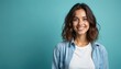© Lubov - Young woman smiles widely at camera. She feels happy, positive, content. She wears casual clothes in studio with copy space. Her cheerful face shows genuine delight.