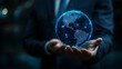© Your Hand Please - Floating glowing Earth at night held in a businessman’s hands symbolizing eco development energy savings and sustainability representing global responsibility innovation and environmental care
