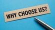 © MstNurjahan - Why choose us text on a beige card with a pen on a blue background