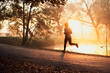 © baranq - Active man jogging in park during autumn sunny morning